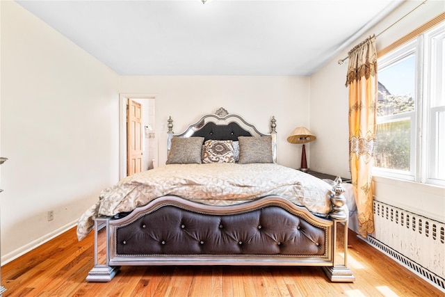 142 Primrose Ave, Mount Vernon, NY 10552 - bedroom with radiator, multiple windows, and wood finished floors
