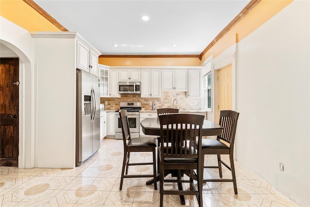 142 Primrose Ave, Mount Vernon, NY 10552 - dining area featuring arched walkways, ornamental molding, recessed lighting, and light tile patterned flooring