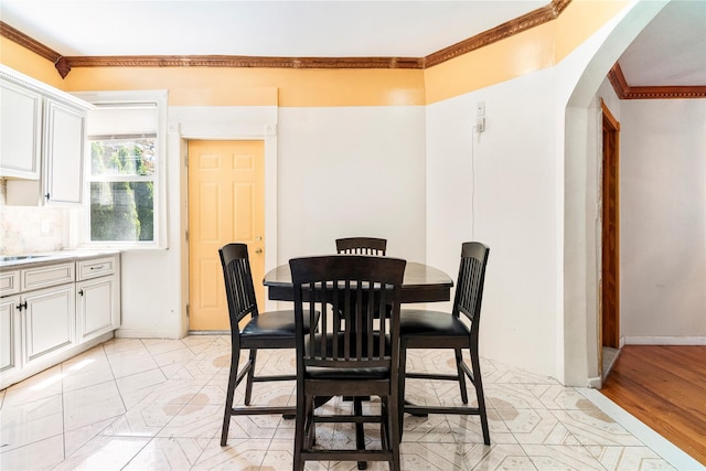 142 Primrose Ave, Mount Vernon, NY 10552 - dining space with crown molding, arched walkways, and baseboards