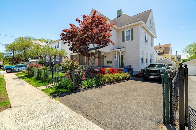 142 Primrose Ave, Mount Vernon, NY 10552 - view of front facade with covered porch, a fenced front yard, a gate, and a chimney