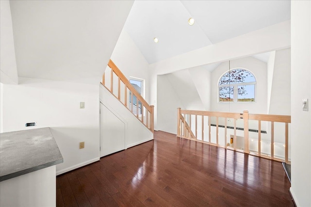 interior space featuring recessed lighting, high vaulted ceiling, and hardwood / wood-style floors
