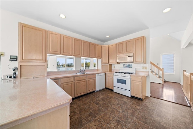 kitchen featuring recessed lighting, light brown cabinetry, backsplash, and white appliances