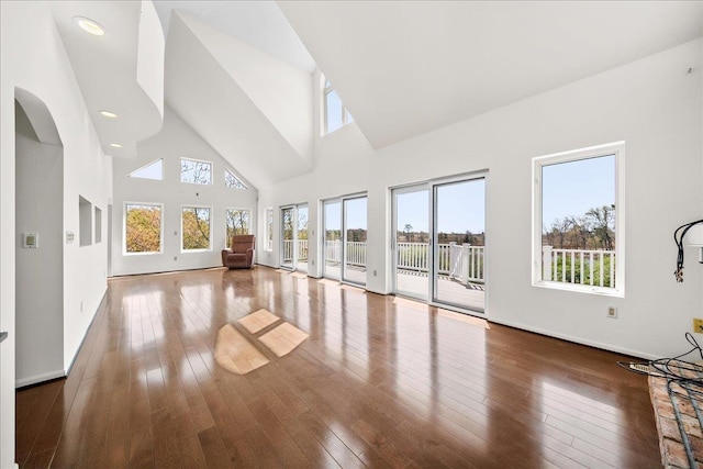 unfurnished sunroom with arched walkways and a healthy amount of sunlight