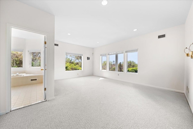 carpeted spare room with baseboards, recessed lighting, and visible vents