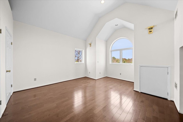 spare room featuring recessed lighting, vaulted ceiling, wood finished floors, and visible vents