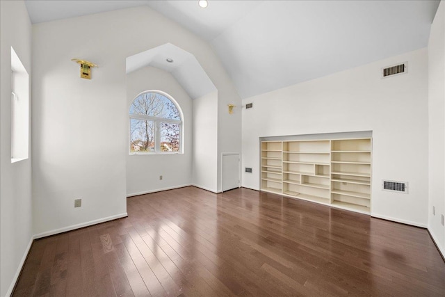unfurnished living room with vaulted ceiling, wood finished floors, and visible vents