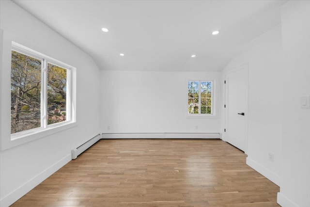 spare room featuring recessed lighting, baseboards, wood finished floors, and vaulted ceiling