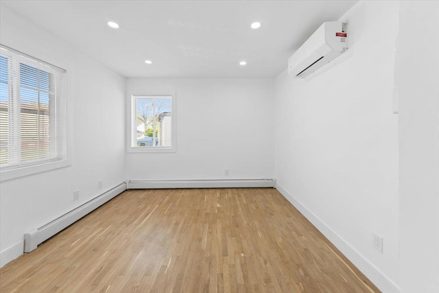 empty room with a wall unit AC, baseboard heating, wood finished floors, baseboards, and recessed lighting