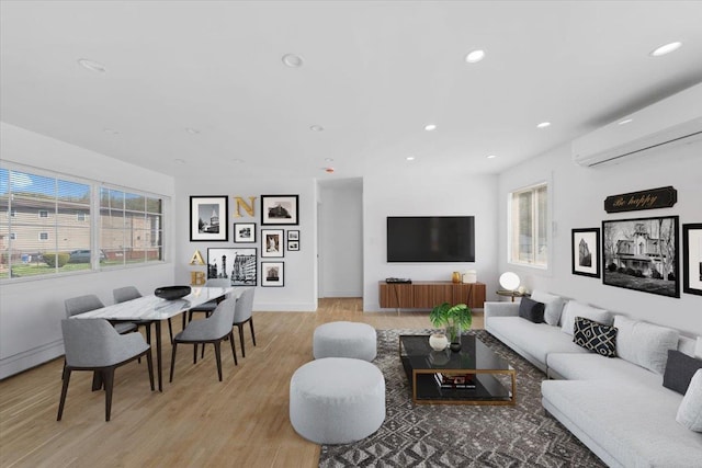 living room featuring recessed lighting, plenty of natural light, and a wall mounted air conditioner