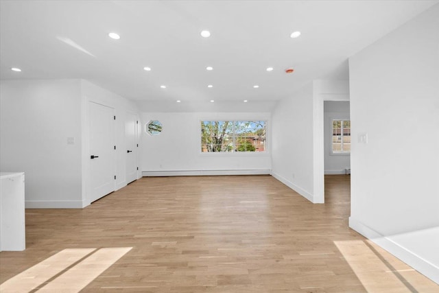 interior space with baseboards, recessed lighting, and light wood-type flooring