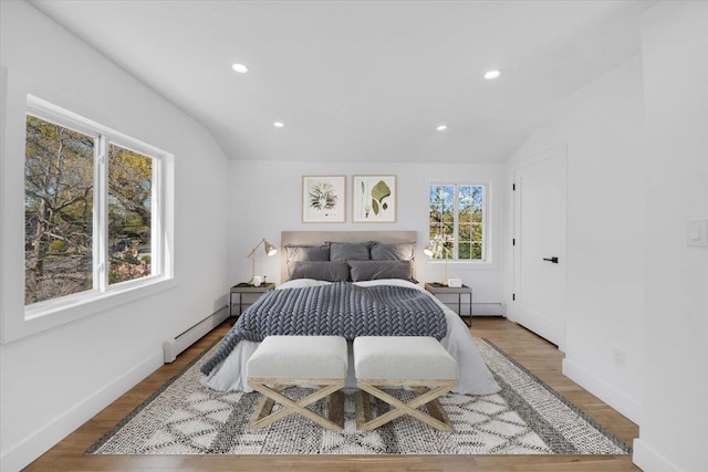 bedroom featuring recessed lighting, wood finished floors, and baseboard heating
