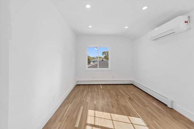 spare room featuring a wall mounted air conditioner, recessed lighting, baseboards, wood finished floors, and a baseboard heating unit
