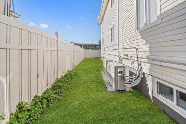 view of yard featuring a fenced backyard and ac unit