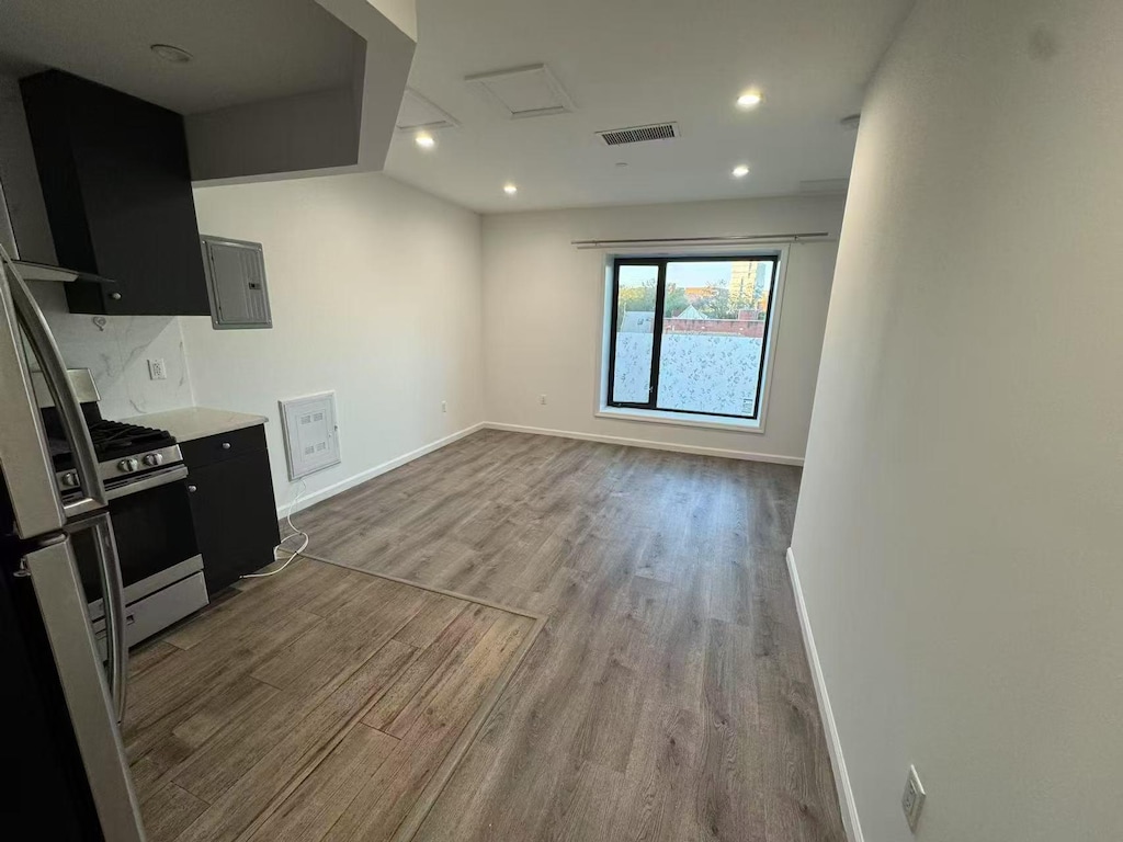 42-08 Bowne St Unit 2A, Flushing, NY 11355 - kitchen featuring dark cabinets, stainless steel gas range, wood finished floors, and visible vents