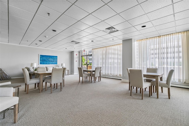 dining space featuring a baseboard heating unit, carpet flooring, visible vents, and baseboards