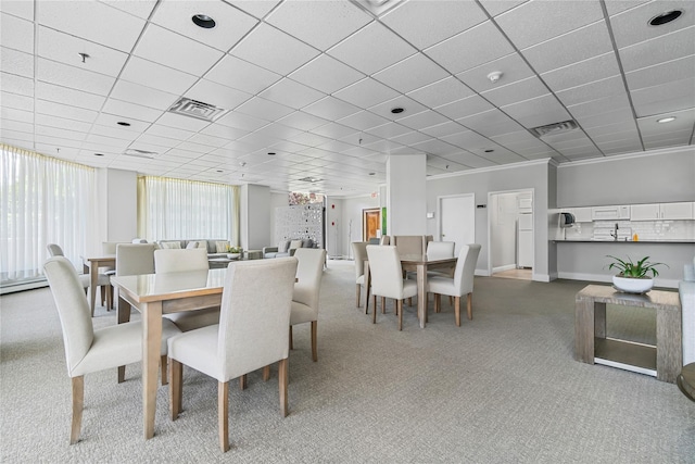 carpeted dining room featuring a drop ceiling, visible vents, and baseboards
