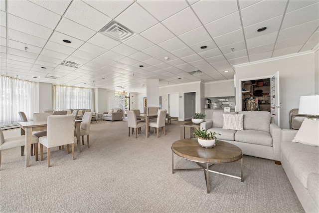 carpeted living area with ornamental molding, visible vents, and plenty of natural light