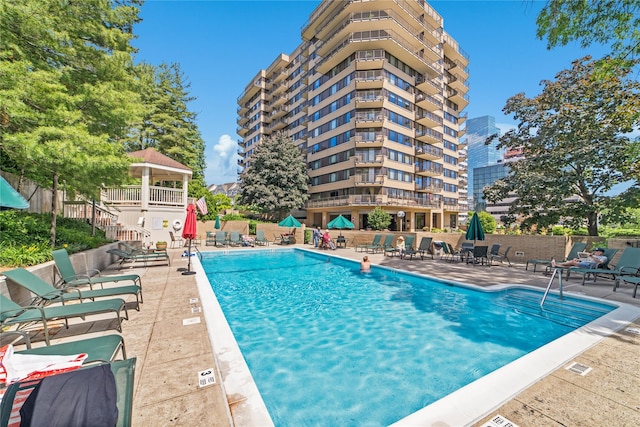 community pool featuring a patio area and fence