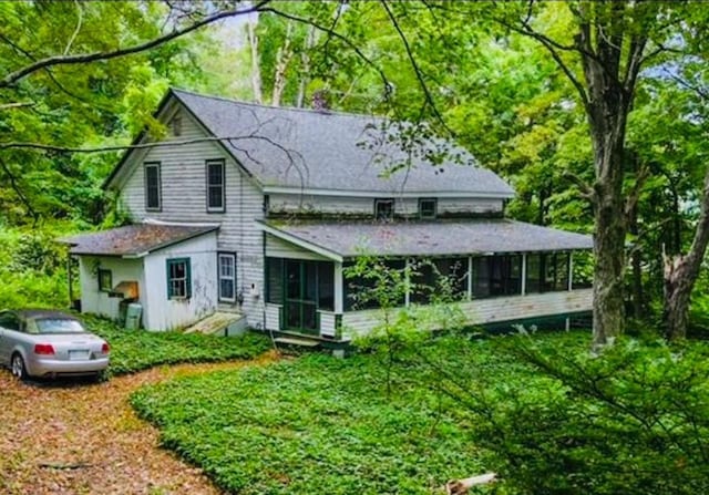 rear view of house with a sunroom