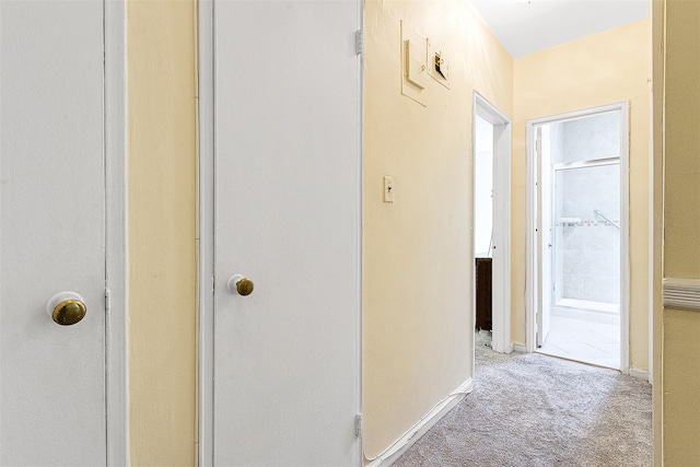 hall with carpet floors and baseboards