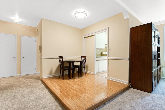 dining room featuring light colored carpet