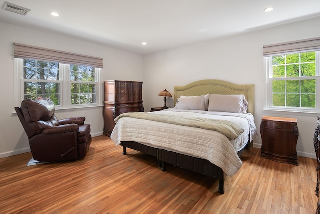 bedroom featuring recessed lighting, baseboards, light wood-type flooring, and visible vents