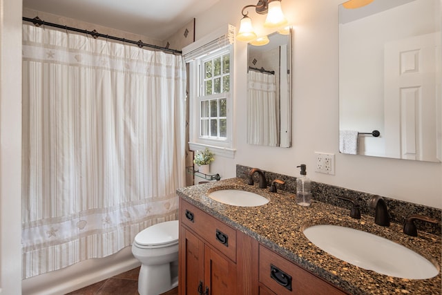 full bath featuring a sink, shower / bath combo with shower curtain, toilet, and double vanity