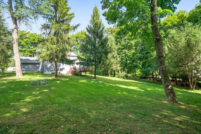 view of yard featuring a wooden deck and stairway