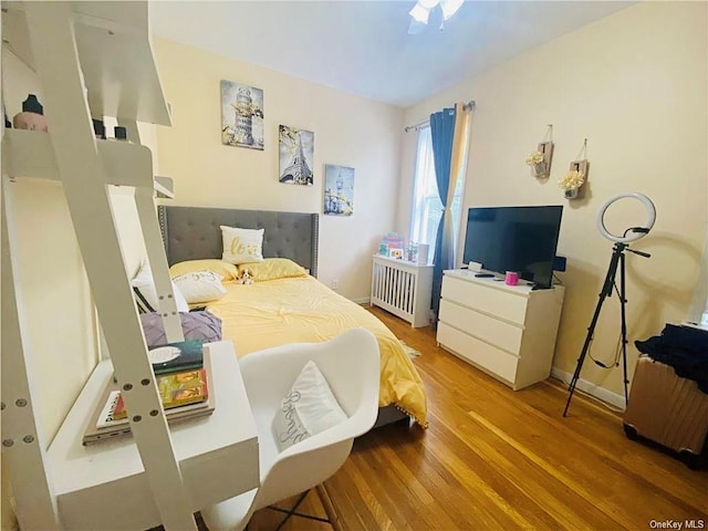 2884 Saint Theresa Ave, Bronx, NY 10461 - bedroom with baseboards, radiator, and wood finished floors