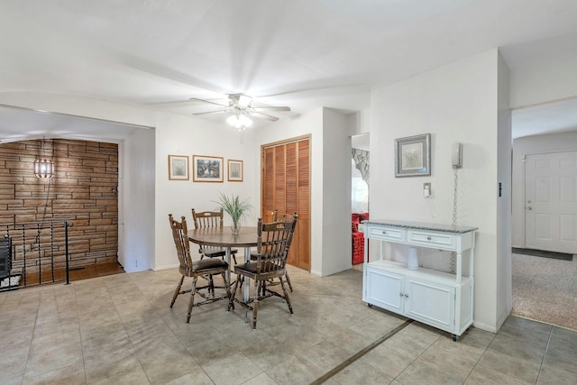 dining space with a ceiling fan and baseboards