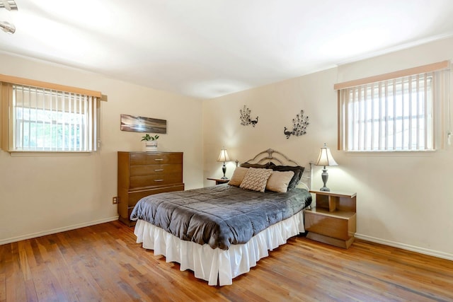 bedroom with wood finished floors and baseboards