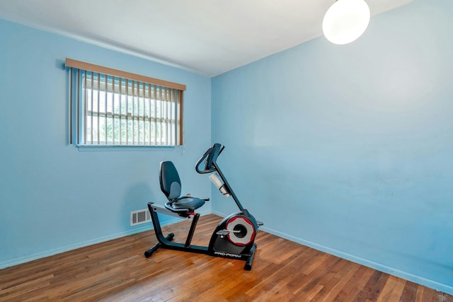 workout area with wood finished floors and baseboards