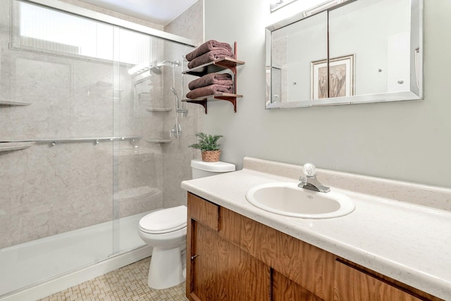 full bath featuring toilet, a shower stall, and vanity