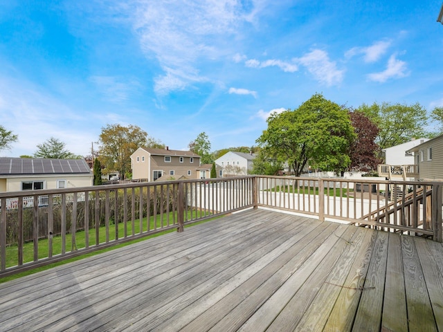 wooden deck featuring a fenced backyard and a residential view
