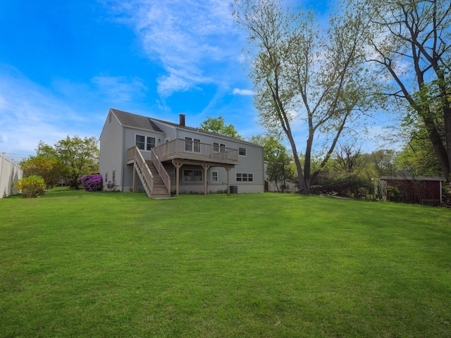 back of house featuring stairway, a deck, a yard, and a chimney