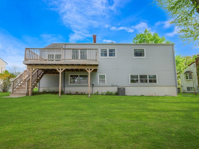 back of property with a lawn, stairs, cooling unit, and a deck