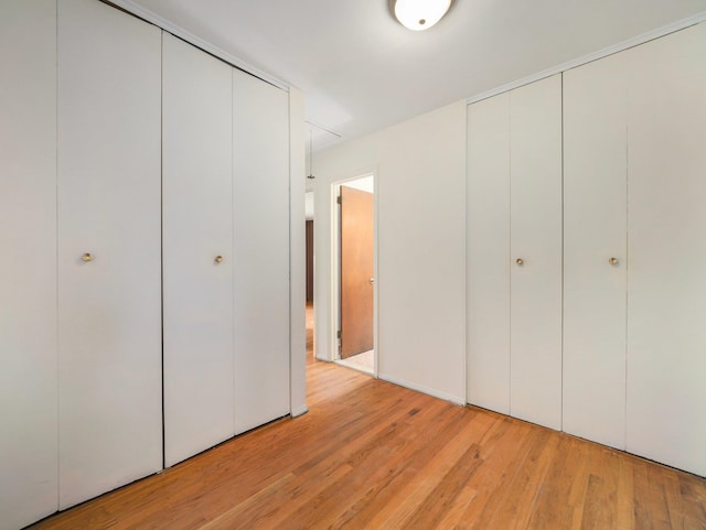 unfurnished bedroom with light wood finished floors