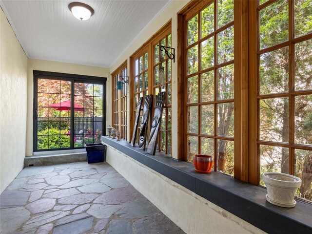 unfurnished sunroom with french doors and stone flooring