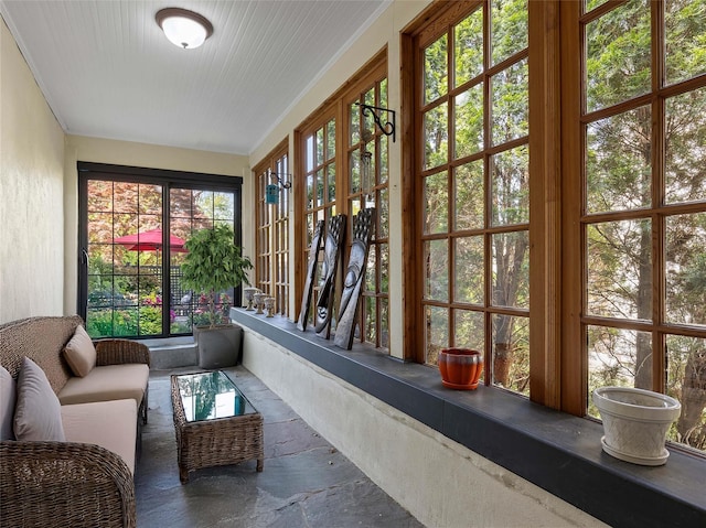 sunroom with french doors and stone finish flooring