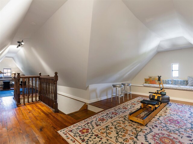 bonus room with baseboards, vaulted ceiling, and hardwood / wood-style flooring