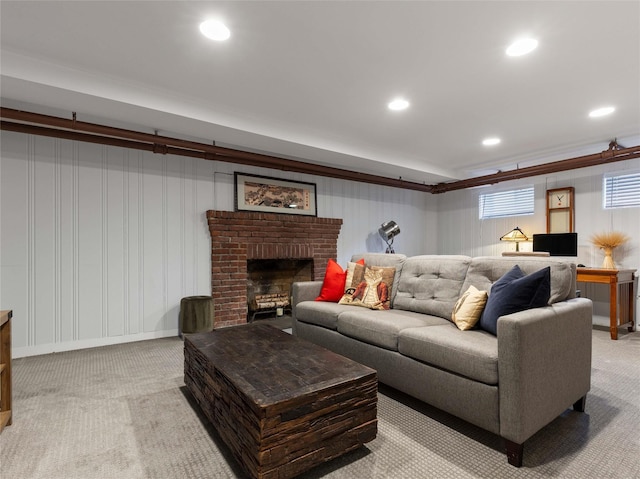 living room featuring recessed lighting, carpet flooring, and a brick fireplace