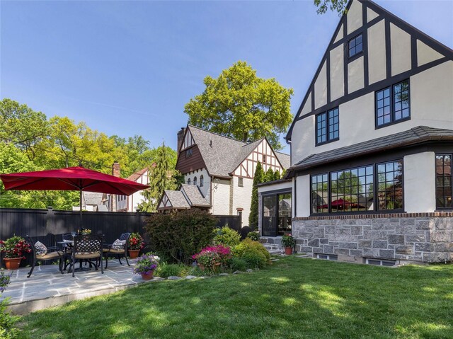 view of yard with fence and a patio