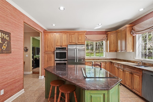 kitchen with plenty of natural light, a sink, appliances with stainless steel finishes, and light tile patterned flooring