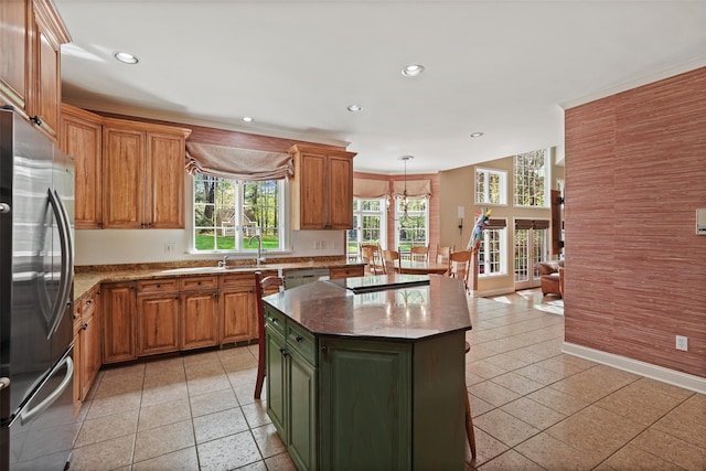 kitchen with recessed lighting, baseboards, appliances with stainless steel finishes, and a center island