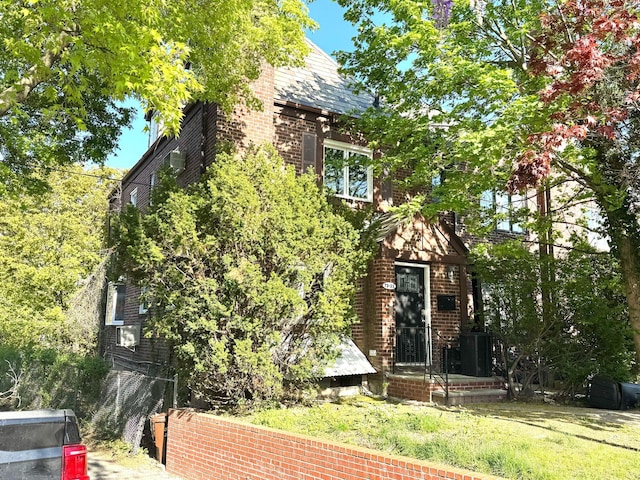 7335 141st Pl, Kew Garden Hills, NY 11367 - view of front facade with brick siding and a front lawn