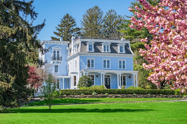 381 W Neck Rd, Lloyd Harbor, NY 11743 - second empire-style home featuring a porch, a front lawn, and mansard roof