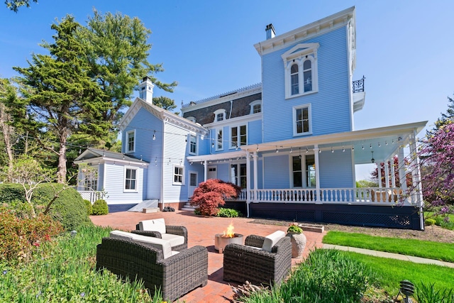 381 W Neck Rd, Lloyd Harbor, NY 11743 - back of house featuring a fire pit, a patio, and a porch