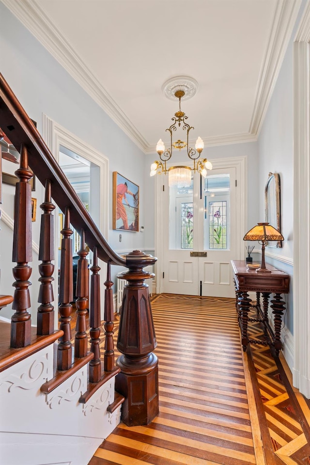 381 W Neck Rd, Lloyd Harbor, NY 11743 - foyer entrance featuring stairway, ornamental molding, wood finished floors, and a notable chandelier