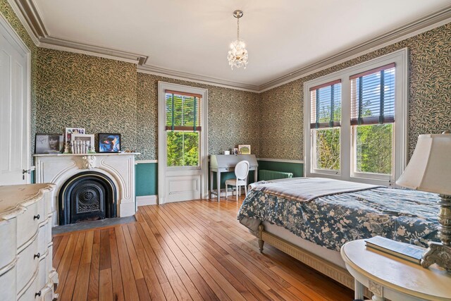 381 W Neck Rd, Lloyd Harbor, NY 11743 - bedroom featuring radiator heating unit, hardwood / wood-style floors, multiple windows, and wallpapered walls