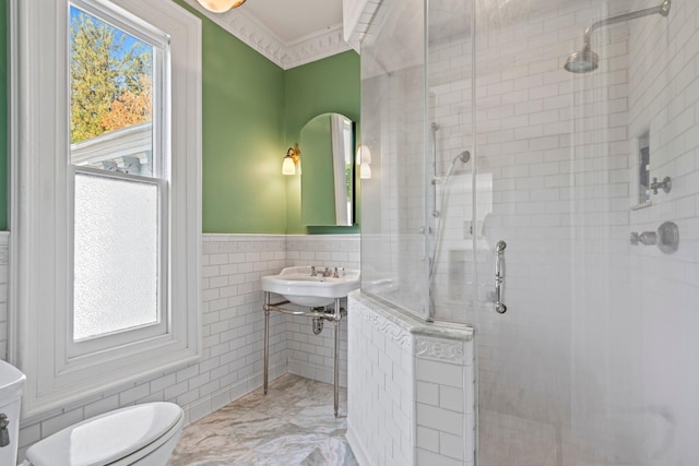 381 W Neck Rd, Lloyd Harbor, NY 11743 - bathroom featuring tile walls, a stall shower, a sink, a wainscoted wall, and toilet